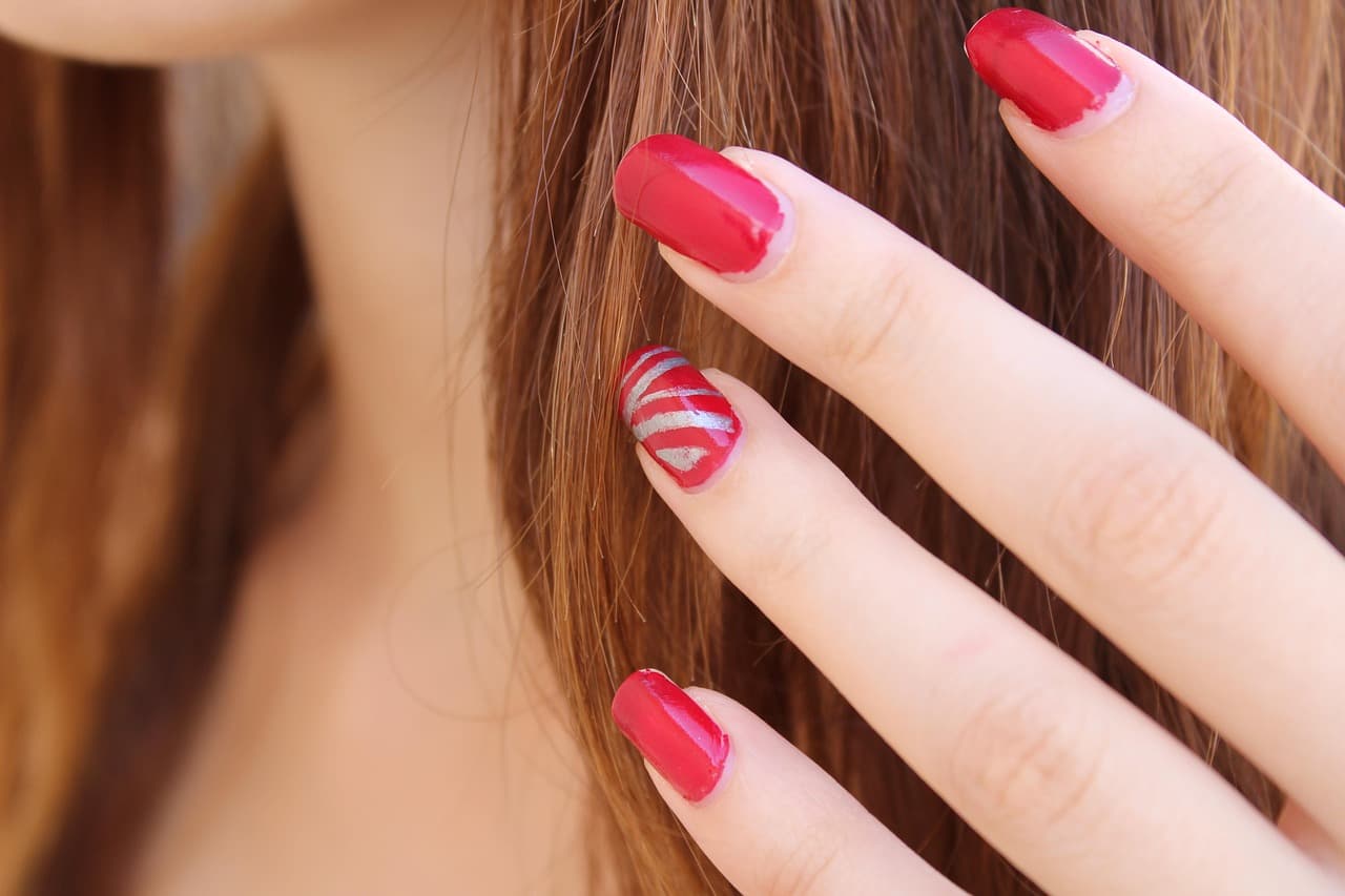 Bright pink nails with a swirl design