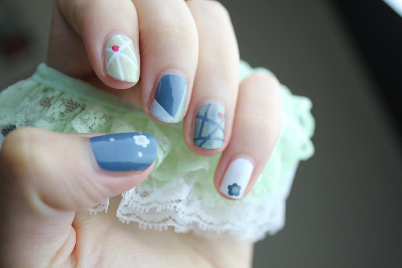 Pastel nail art with blue and patterned nails